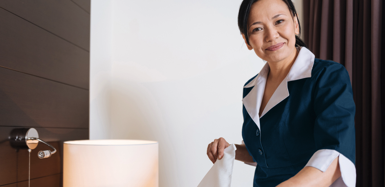 Woman cleaning hotel room